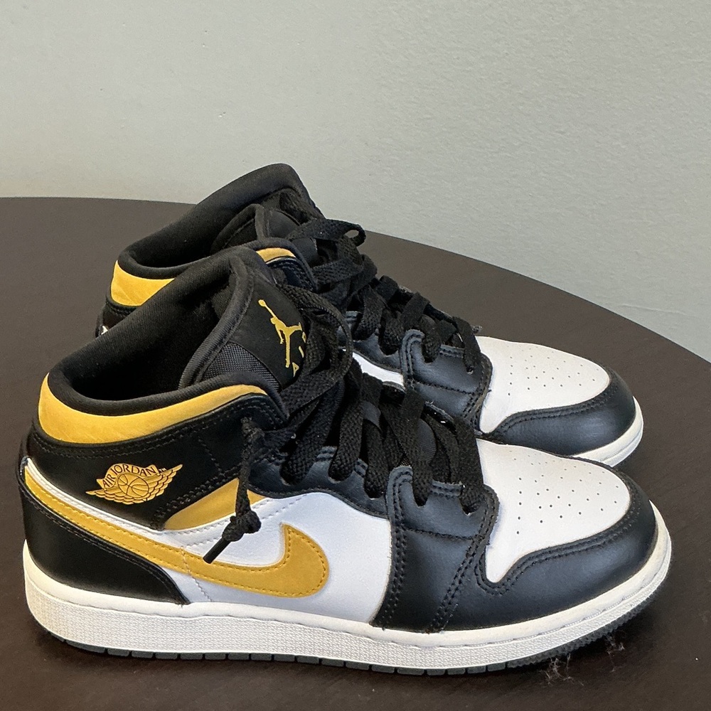 Nike Air Jordan 1 Mid white, pollen, and black colorway
